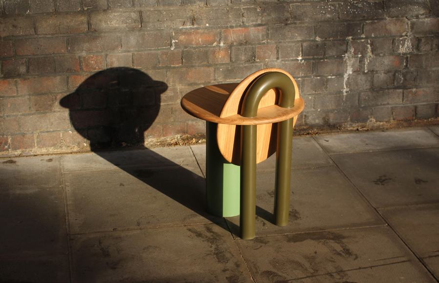 Rear view of the stool and its shadow on brick