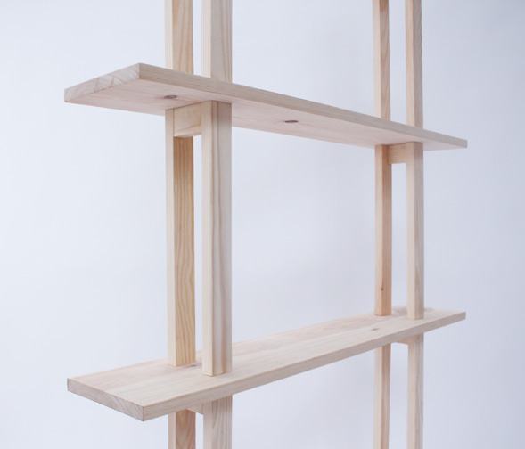 Two shelves held between the slender legs