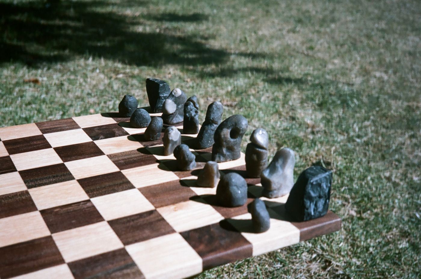 Dark flint pieces in a row along the board edge, out on the grass